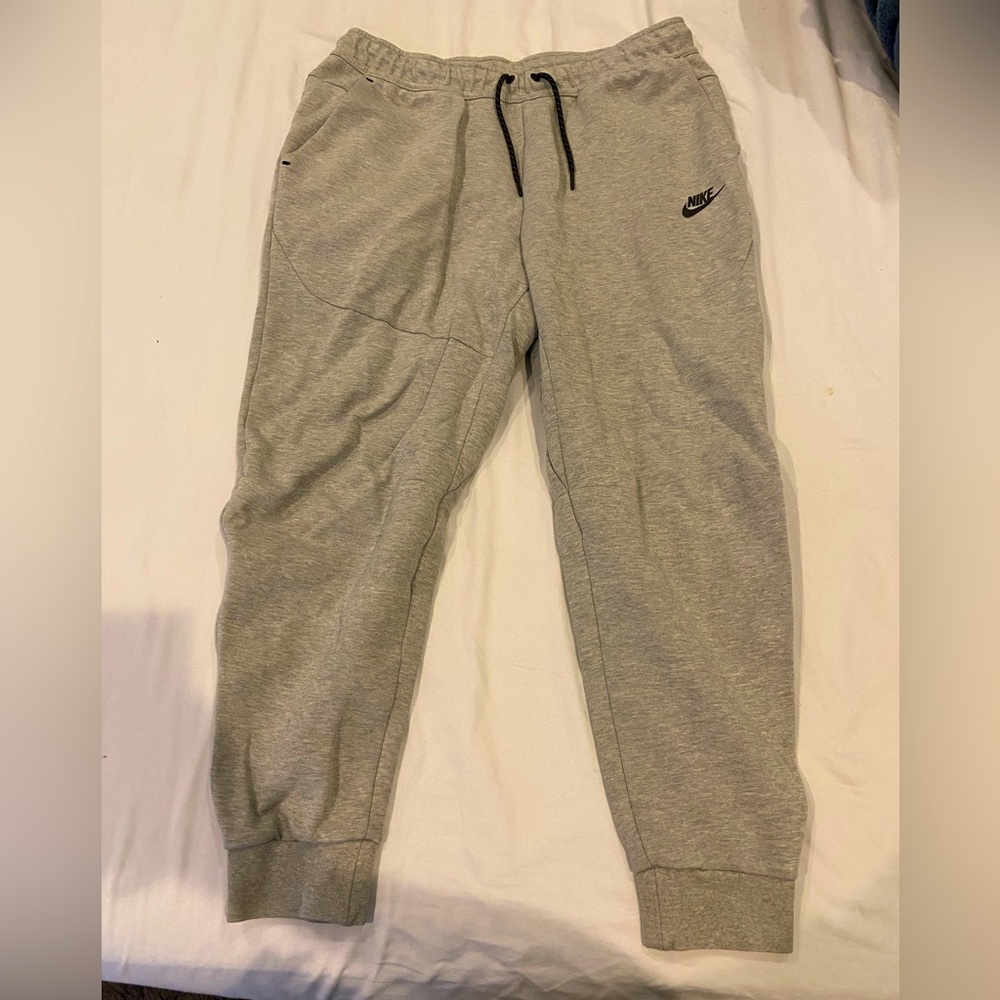 Grey Nike drawstring sweatpants with zipper pocket